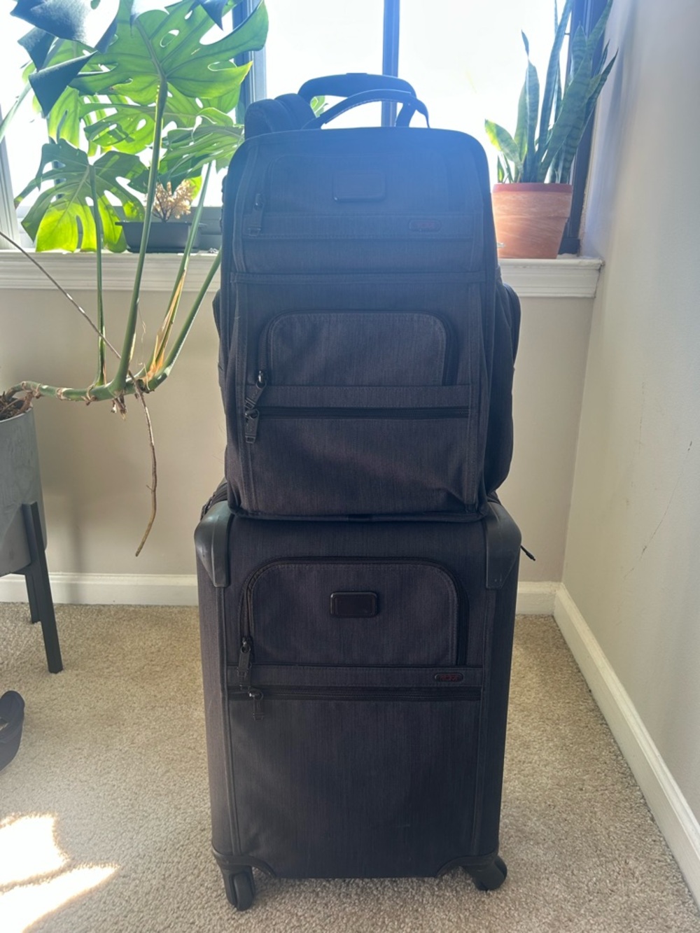 Tumi Black Rolling Suitcase with Black Backpack Set